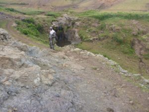 the scout, the Scoria slopes and a small waterfall. - Semien Mountains