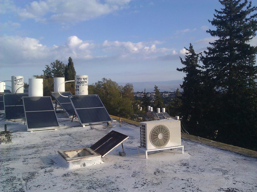 The view of the Haifa bay from the roof, other solar collectors and scary fact there is no fence to hold you from falling! =o Solar Water Heating System