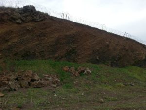 A section in the mountains that shows the Scoria layers. This stones are mined and used in gardens. - volcanoes