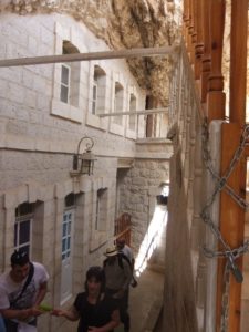 The main corridor of the Cartanel: On one side the rock and on the other doors to rooms of pilgrims who want to meditate