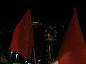 Red flags at the protest with the Bhai temple at the background.