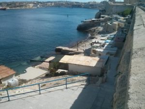 A small village on the shore below the fortress of Valletta and the bay