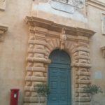 A red mailbox in the street of Valletta