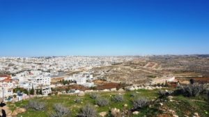 North-East on the left (far where the trees) is the Israeli settlement of Kiryat Arba - South mount Hebron