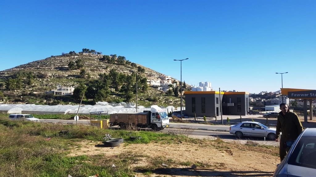 The gas station of El-Fawwar and the hill above it    - South mount Hebron