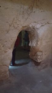 The entrance to the old caves behind the altar in the modern hall in Burial caves in Saint-Étienne Basilica