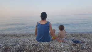 Atzva and Jannaeus sitting on beach on the afternoon