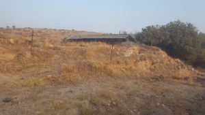 The north wall from the inner court, with a canopy over the location of the wall movement - Metzad Atert