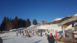 Parents waiting for the kids to finish ski school day at the bottom of the slop