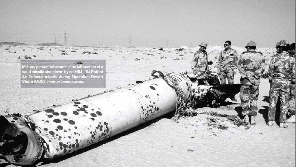 Military personnel examine the tail section of a scud missile  shot down by an-MIM 104 Patriot Air Defense Missile. (Source: Wikipedia)