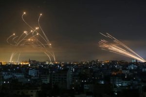 The original picture by Anas Baba (of AFP) - Israel's Iron Dome defense system and rockets launched from Beit Lahia in the Gaza Strip rise into the night sky on May 14. - Victory picture - Guardian of the walls - Day 10