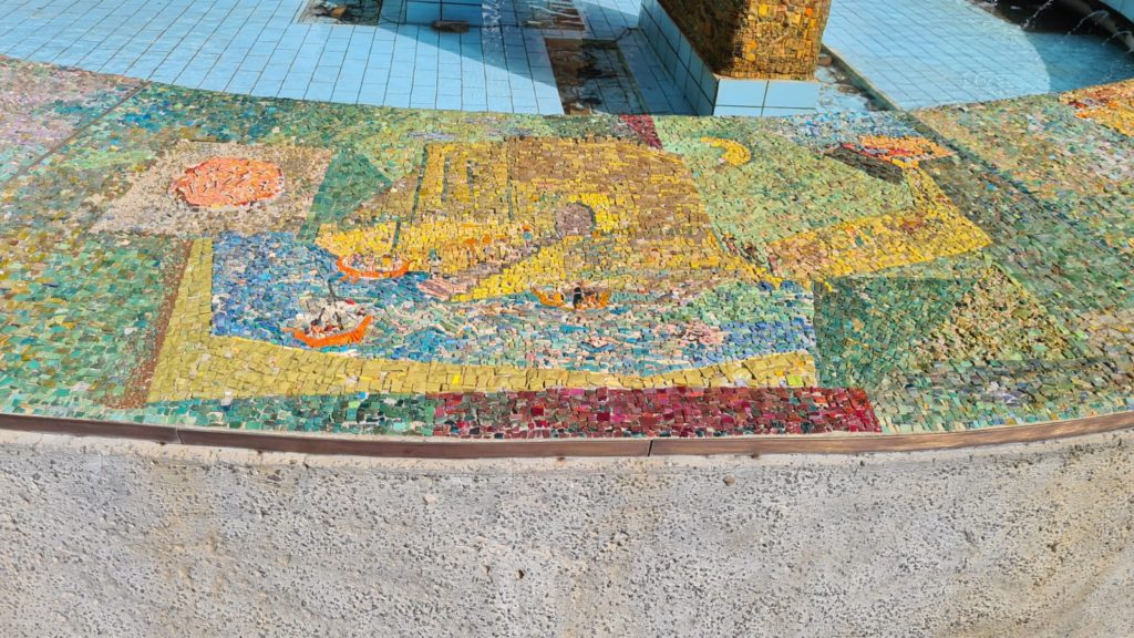 The scenes on the mosaic on the curve around the fountain