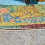 The scenes on the mosaic on the curve around the fountain