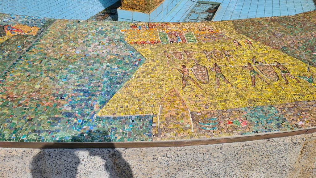 The scenes on the mosaic on the curve around the fountain