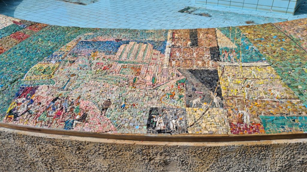 The scenes on the mosaic on the curve around the fountain