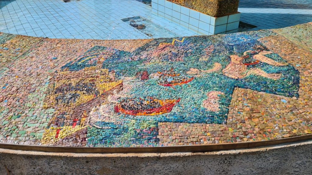 The scenes on the mosaic on the curve around the fountain