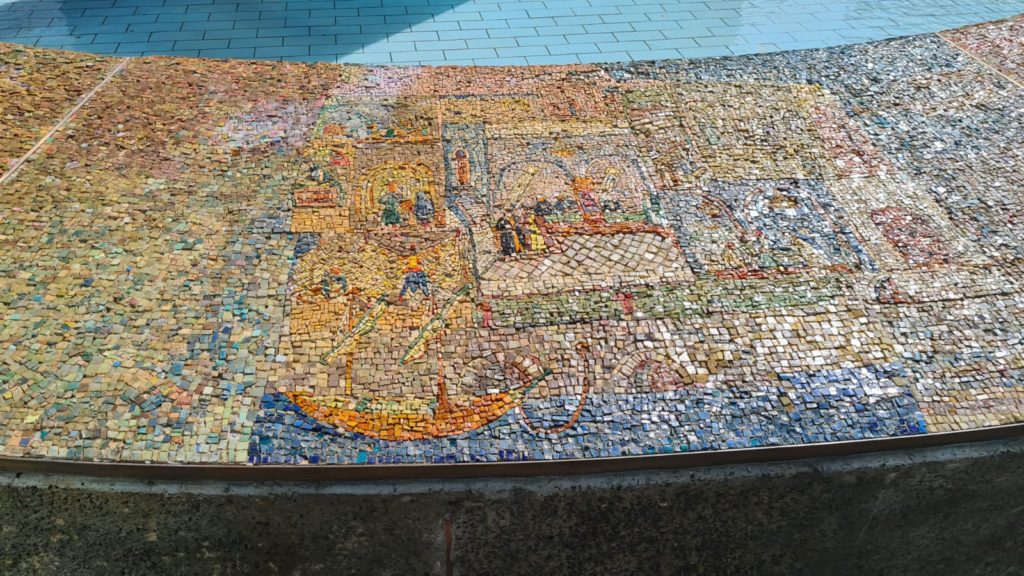 The scenes on the mosaic on the curve around the fountain