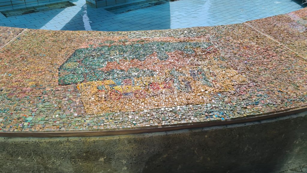 The scenes on the mosaic on the curve around the fountain