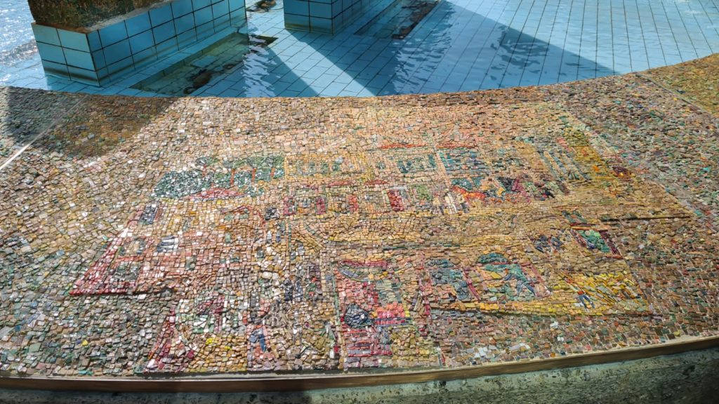 The scenes on the mosaic on the curve around the fountain