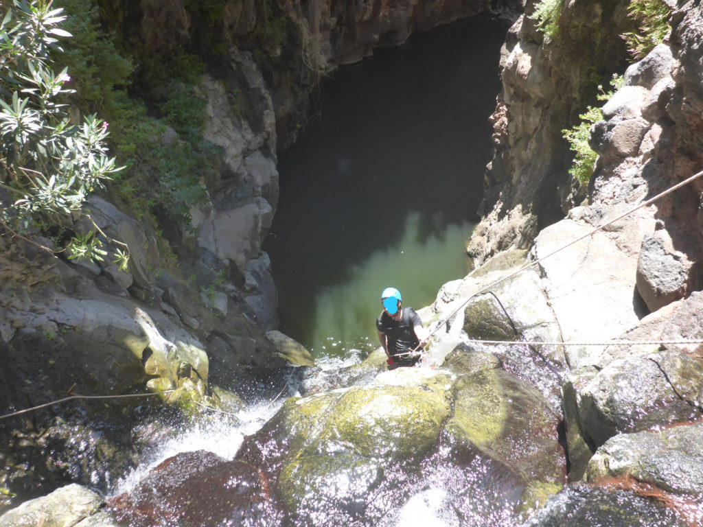 Rappelling down the third waterfall - 20m high with positive slope. On the bottom there is a 50m long pool