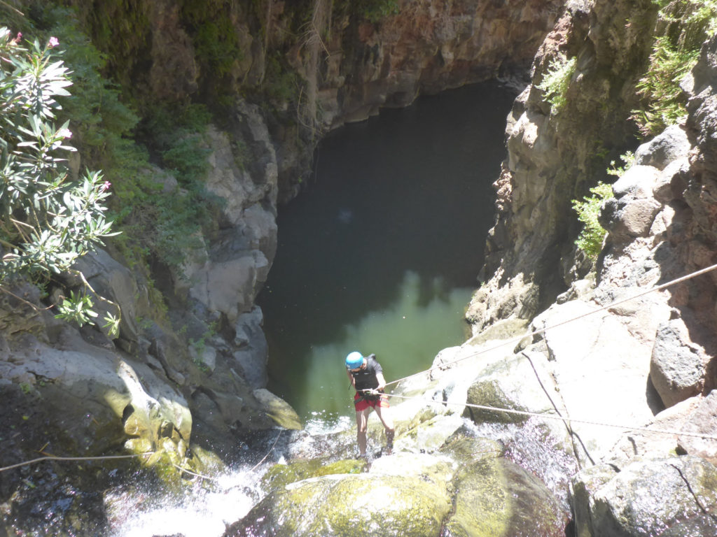 Rappelling down the third waterfall - 20m high with positive slope. On the bottom there is a 50m long pool