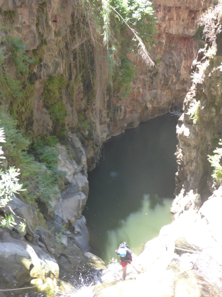 Rappelling down the third waterfall - 20m high with positive slope. On the bottom there is a 50m long pool