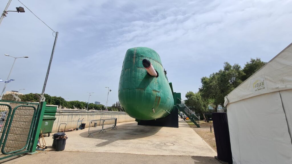 The front of the submarine with a torpedo missile half way out