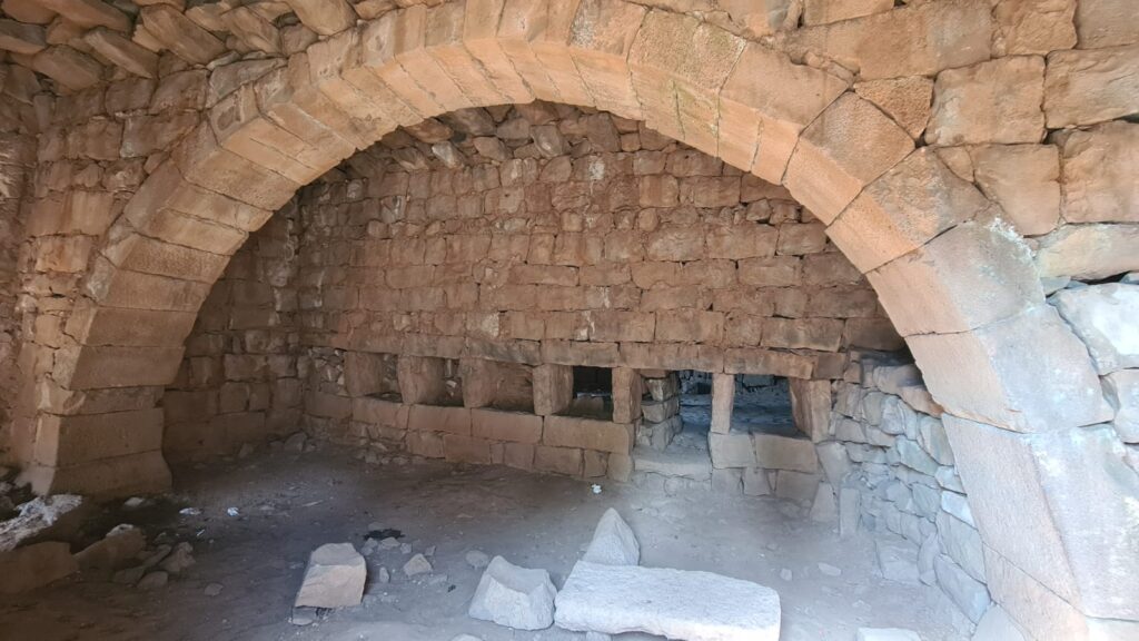 An arch and openings. The windows are typical for Hauranic architecture