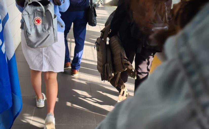 Two women on their way to work with bulletproof tactical vests in their hands. Normal