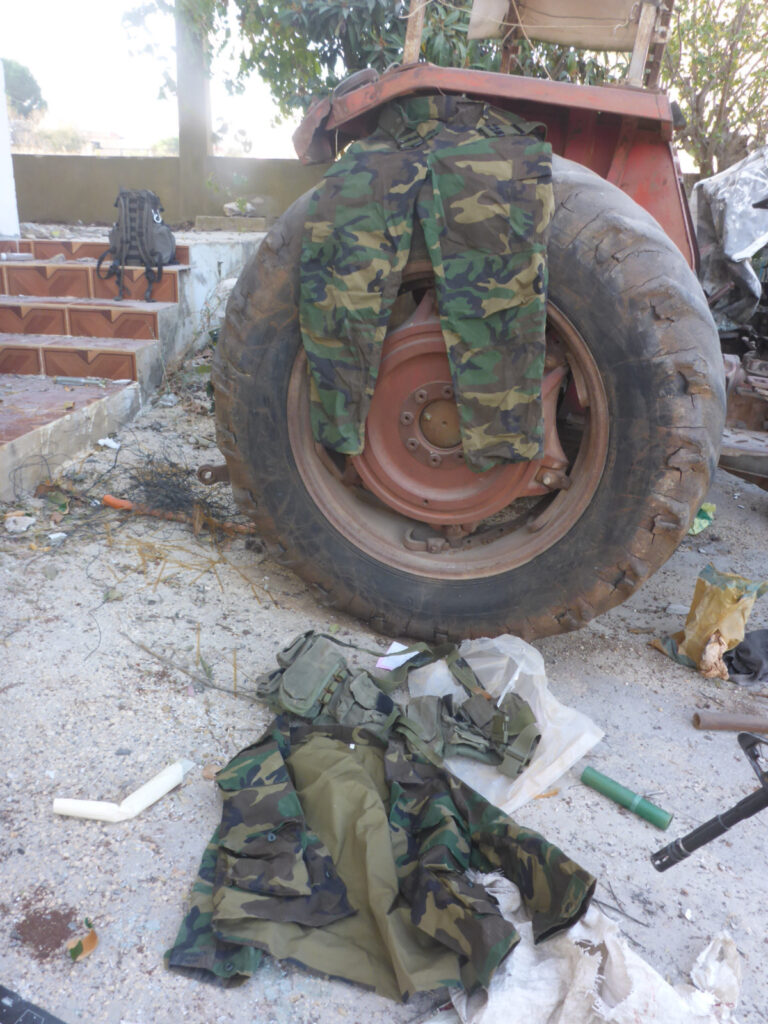 The soldier equipment we found in it: uniforms, helmet, bulletproof vest and... - weapons