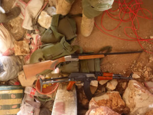 an AK-47 and fighting vest with 8 full magazines