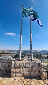 The flags' masts on top the hill, covered with stickers of the fallen from the war - Castel