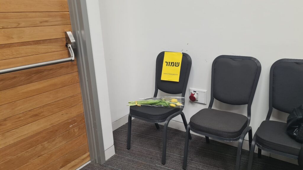 The empty chair in each lecture room in the The 15th Conference on Construction and Infrastructure (where Atzva lectured)